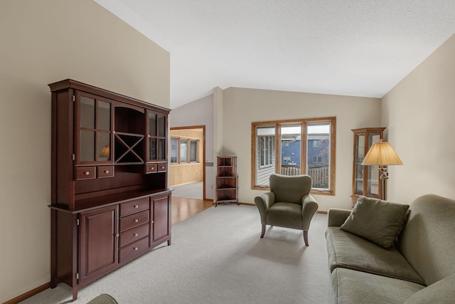 living room with light colored carpet, baseboards, and vaulted ceiling