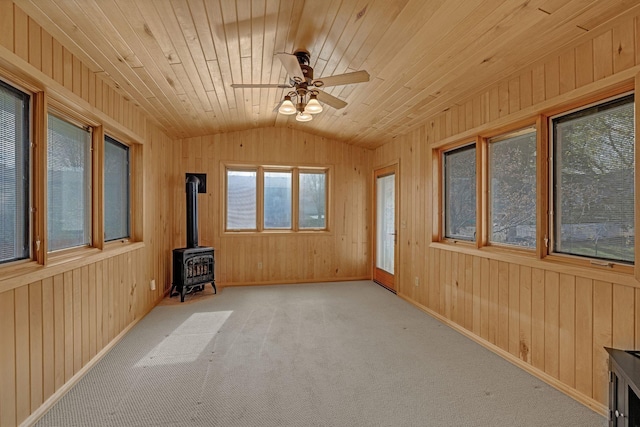 unfurnished sunroom with a wood stove