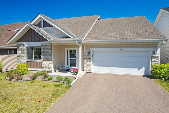 4922 93rd Way N, Brooklyn Park, MN 55443 - view of front of home with stone siding, a shingled roof, and asphalt driveway
