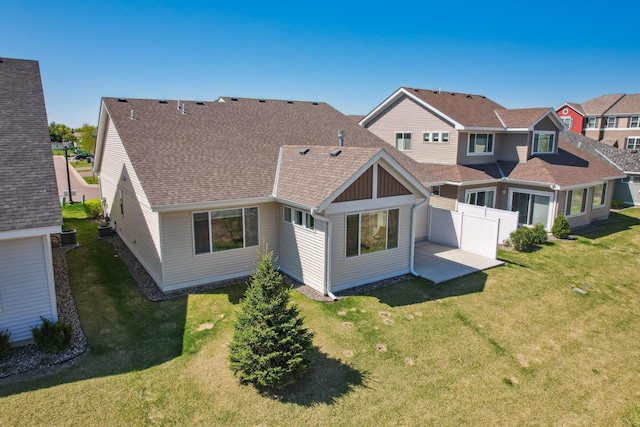 4922 93rd Way N, Brooklyn Park, MN 55443 - back of property with a patio, board and batten siding, and a shingled roof