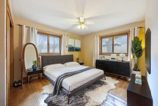 463 Minnesota St S, Stillwater, MN 55003 - bedroom featuring light wood-type flooring, arched walkways, and a ceiling fan