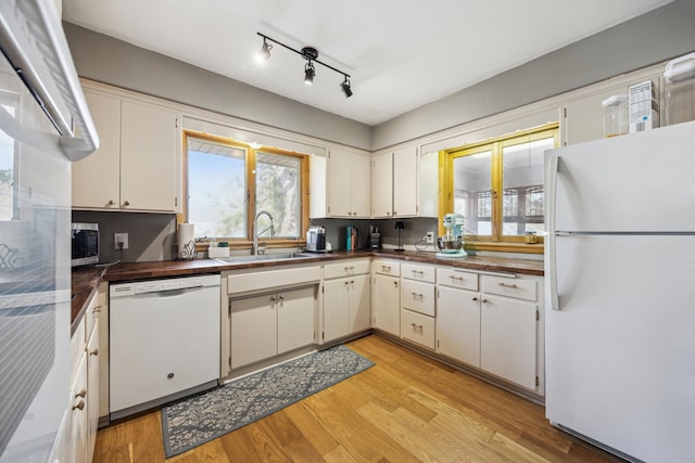 463 Minnesota St S, Stillwater, MN 55003 - kitchen with white appliances, a sink, light wood-style floors, and white cabinetry