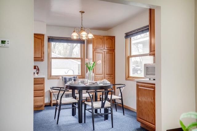 dining space featuring a notable chandelier, plenty of natural light, baseboards, and carpet floors