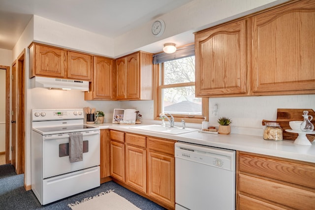 kitchen featuring under cabinet range hood, light countertops, a sink, and white appliances