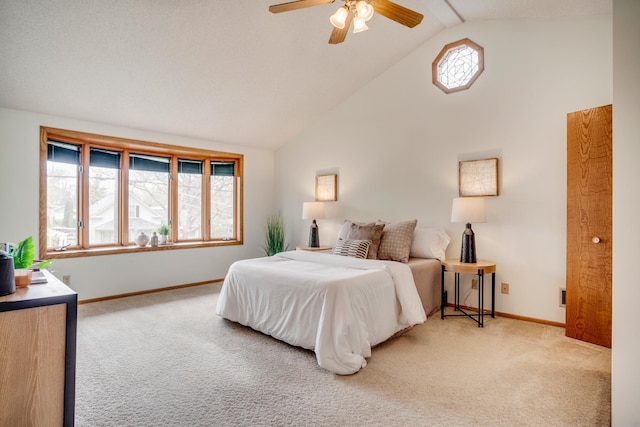 bedroom featuring light carpet, baseboards, high vaulted ceiling, and a ceiling fan