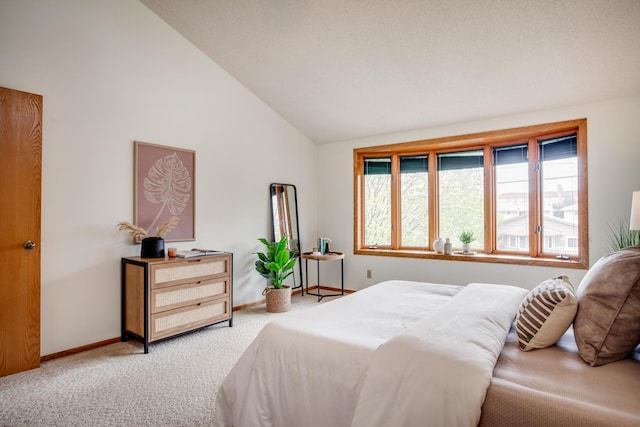 carpeted bedroom featuring vaulted ceiling, baseboards, and multiple windows