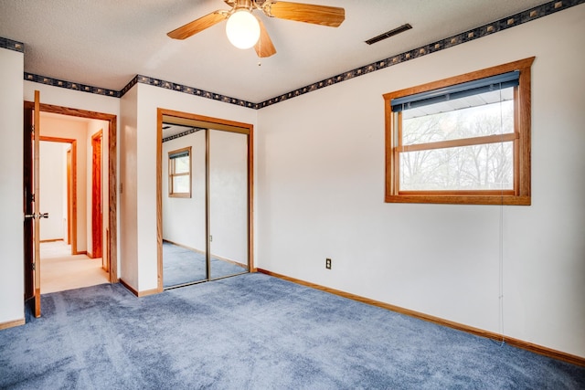 unfurnished bedroom with baseboards, a closet, visible vents, and carpet floors