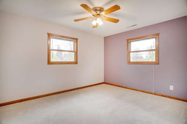 carpeted empty room with baseboards and plenty of natural light