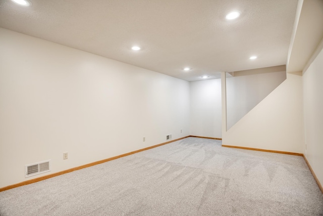 unfurnished room with light carpet, baseboards, visible vents, and recessed lighting