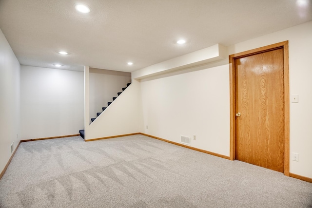 finished below grade area with carpet, visible vents, and recessed lighting