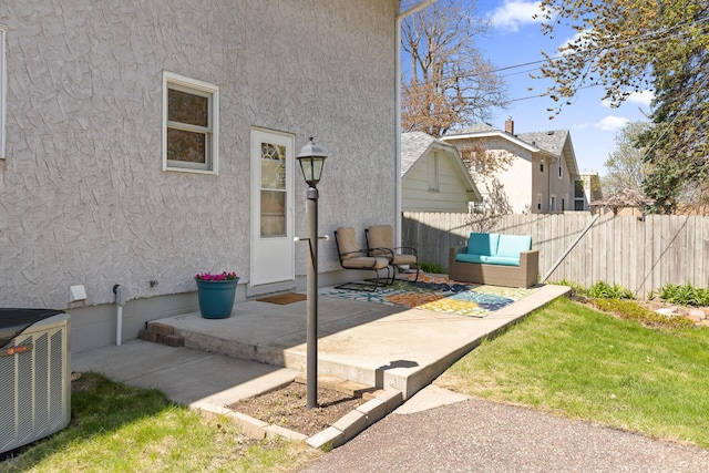 view of patio with central AC unit and fence