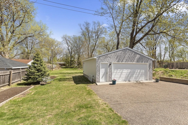 detached garage featuring fence