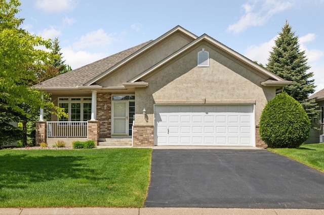 19077 Inman Trl, Lakeville, MN 55044 - view of front of home with asphalt driveway, a front yard, an attached garage, and stucco siding