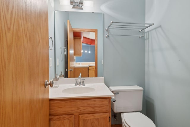 bathroom featuring toilet and vanity