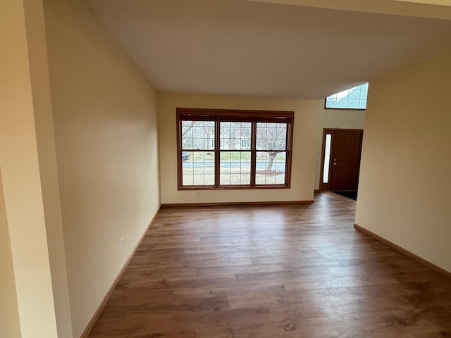 937 Briar Glen Ln, Woodbury, MN 55129 - empty room featuring plenty of natural light, wood finished floors, lofted ceiling, and baseboards