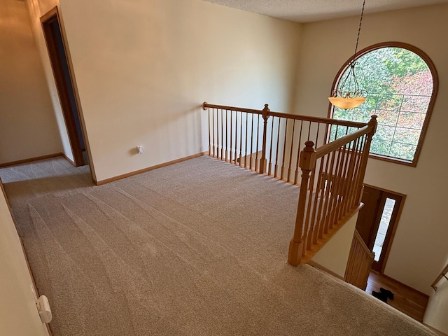 937 Briar Glen Ln, Woodbury, MN 55129 - corridor featuring an upstairs landing, carpet flooring, baseboards, and a textured ceiling