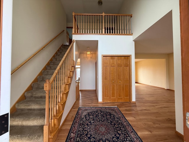 937 Briar Glen Ln, Woodbury, MN 55129 - stairs featuring wood finished floors, a towering ceiling, and baseboards