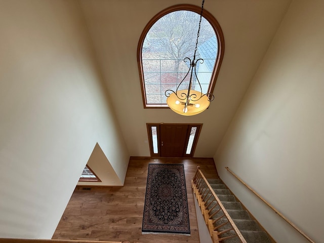 937 Briar Glen Ln, Woodbury, MN 55129 - entrance foyer with a chandelier, a towering ceiling, and wood finished floors