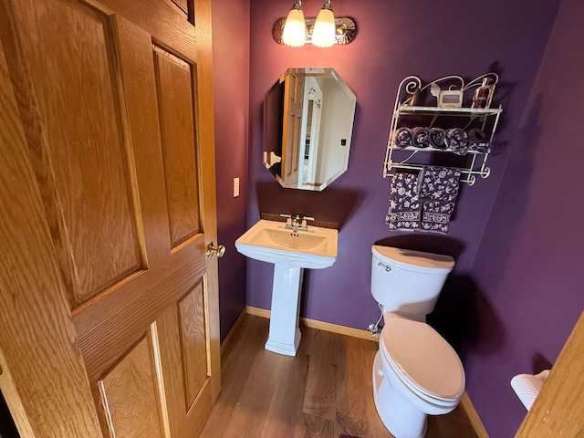 937 Briar Glen Ln, Woodbury, MN 55129 - bathroom with wood finished floors, toilet, and baseboards