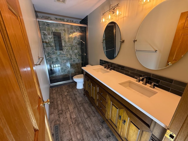 937 Briar Glen Ln, Woodbury, MN 55129 - full bath featuring toilet, a stall shower, tasteful backsplash, double vanity, and wood finished floors