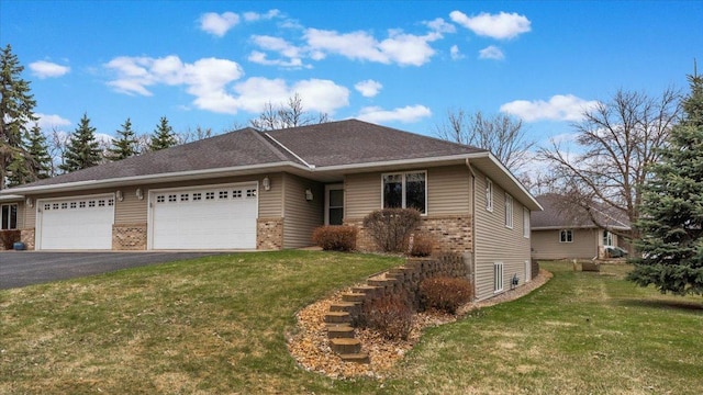 single story home featuring brick siding, a garage, aphalt driveway, and a front yard
