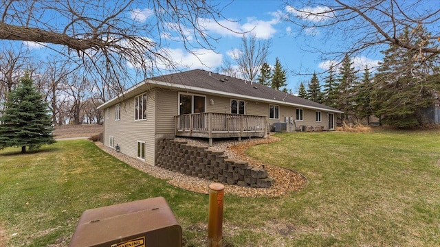 rear view of property featuring a yard, a deck, and central AC unit