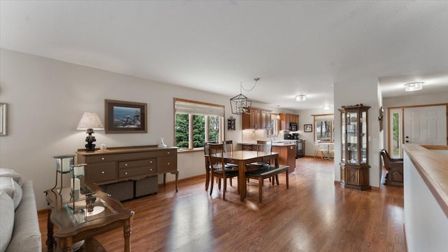 dining room featuring dark wood-type flooring and baseboards