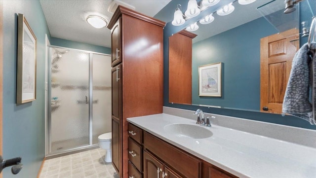 full bathroom featuring vanity, a shower stall, and toilet