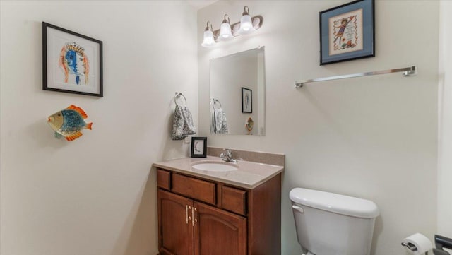 half bathroom featuring toilet and vanity