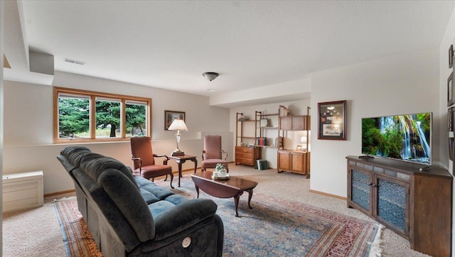 living area with light colored carpet, baseboards, and visible vents