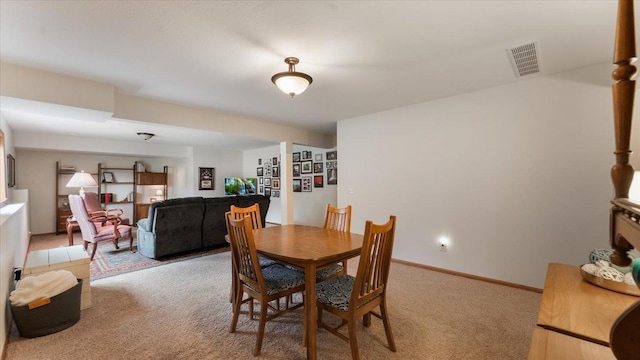 dining area featuring visible vents and light carpet