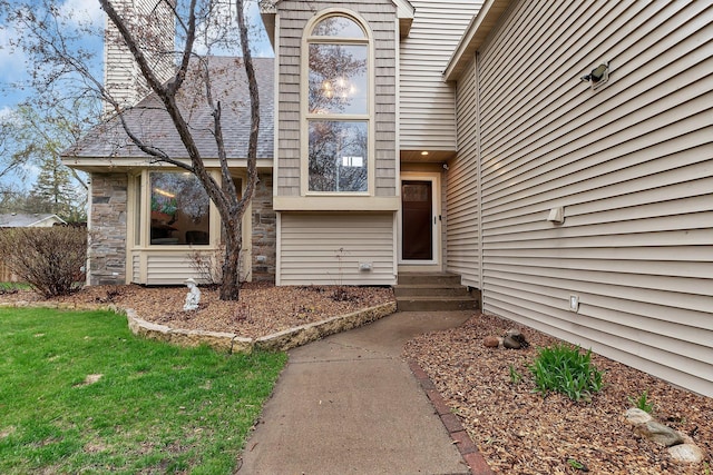 doorway to property featuring stone siding