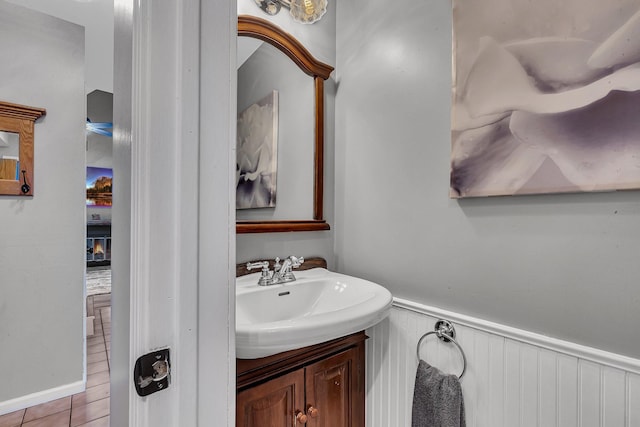 bathroom with vanity and a wainscoted wall