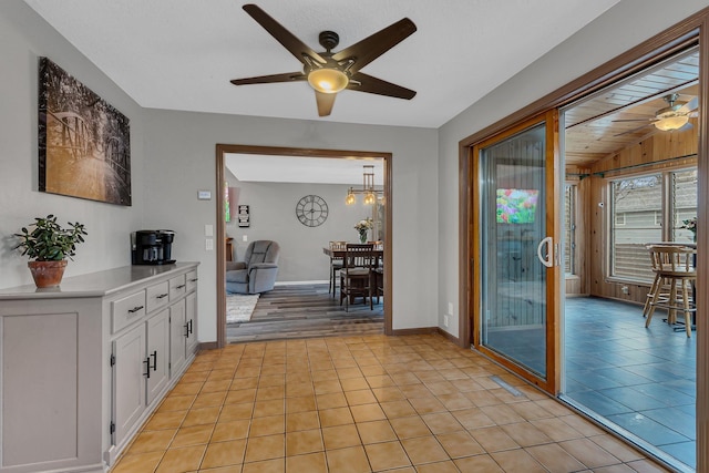 interior space featuring baseboards and light tile patterned floors