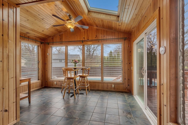 sunroom with wooden walls, wooden ceiling, and vaulted ceiling with skylight