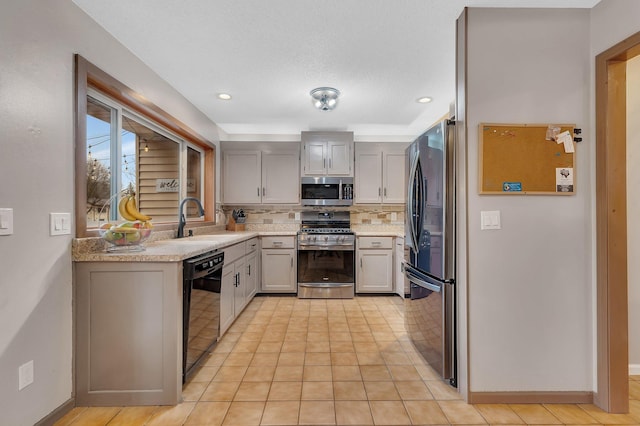 kitchen featuring a sink, light countertops, stainless steel appliances, recessed lighting, and backsplash