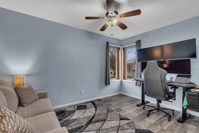 office space with a ceiling fan, baseboards, and wood finished floors