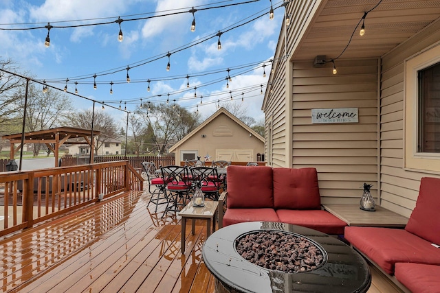 deck featuring fence, an outdoor living space with a fire pit, and outdoor dining area