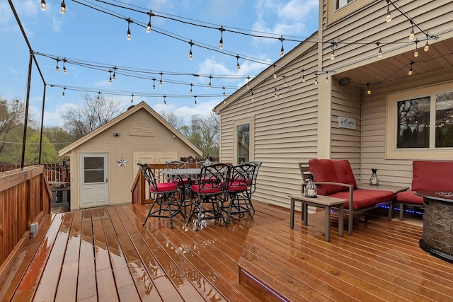 deck featuring outdoor dining area and an outdoor hangout area