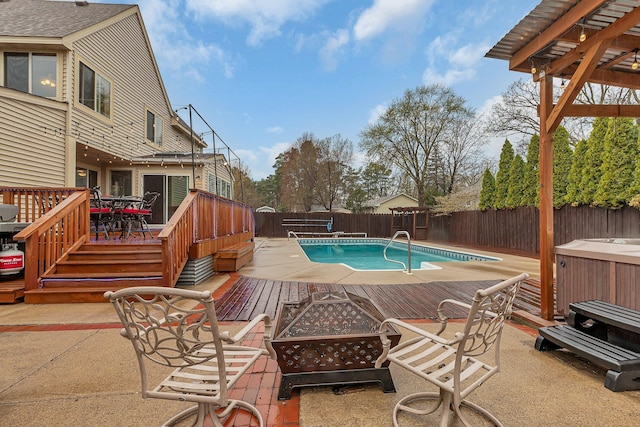 view of pool featuring a deck, a fenced in pool, a fenced backyard, an outdoor fire pit, and outdoor dining space