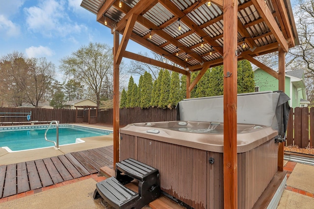 view of swimming pool featuring a fenced in pool, a fenced backyard, a hot tub, and a wooden deck
