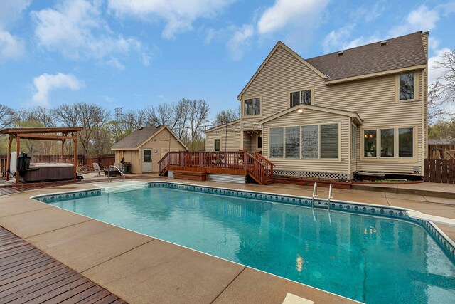 view of pool with a fenced in pool, a fenced backyard, a hot tub, and a wooden deck