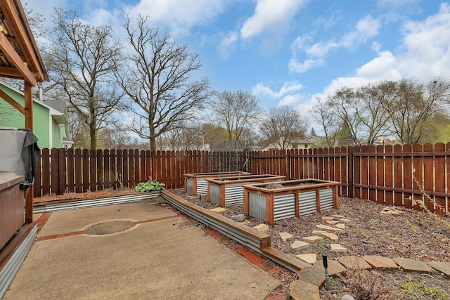 exterior space with a patio, a fenced backyard, and a garden