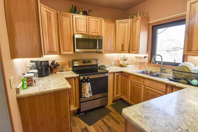 11287 135th Ave NE, Thief River Falls, MN 56701 - kitchen featuring dark wood-style flooring, a sink, and appliances with stainless steel finishes