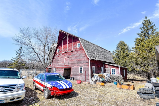 11287 135th Ave NE, Thief River Falls, MN 56701 - view of property exterior with a gambrel roof, an outbuilding, roof with shingles, fence, and a barn