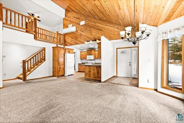 unfurnished living room with wood ceiling, light colored carpet, baseboards, and stairway
