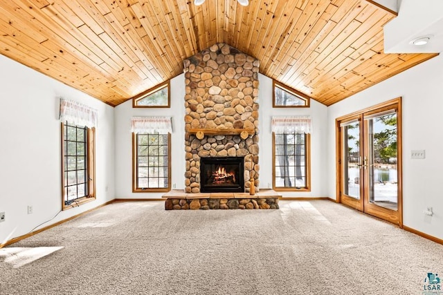 unfurnished living room with carpet floors, baseboards, wooden ceiling, and a fireplace