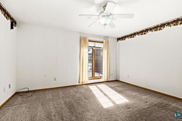 carpeted spare room with baseboards and ceiling fan