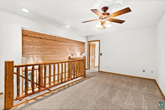 carpeted spare room with recessed lighting, baseboards, and a ceiling fan