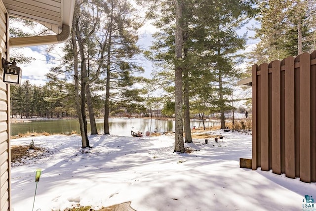 view of yard featuring a water view and fence